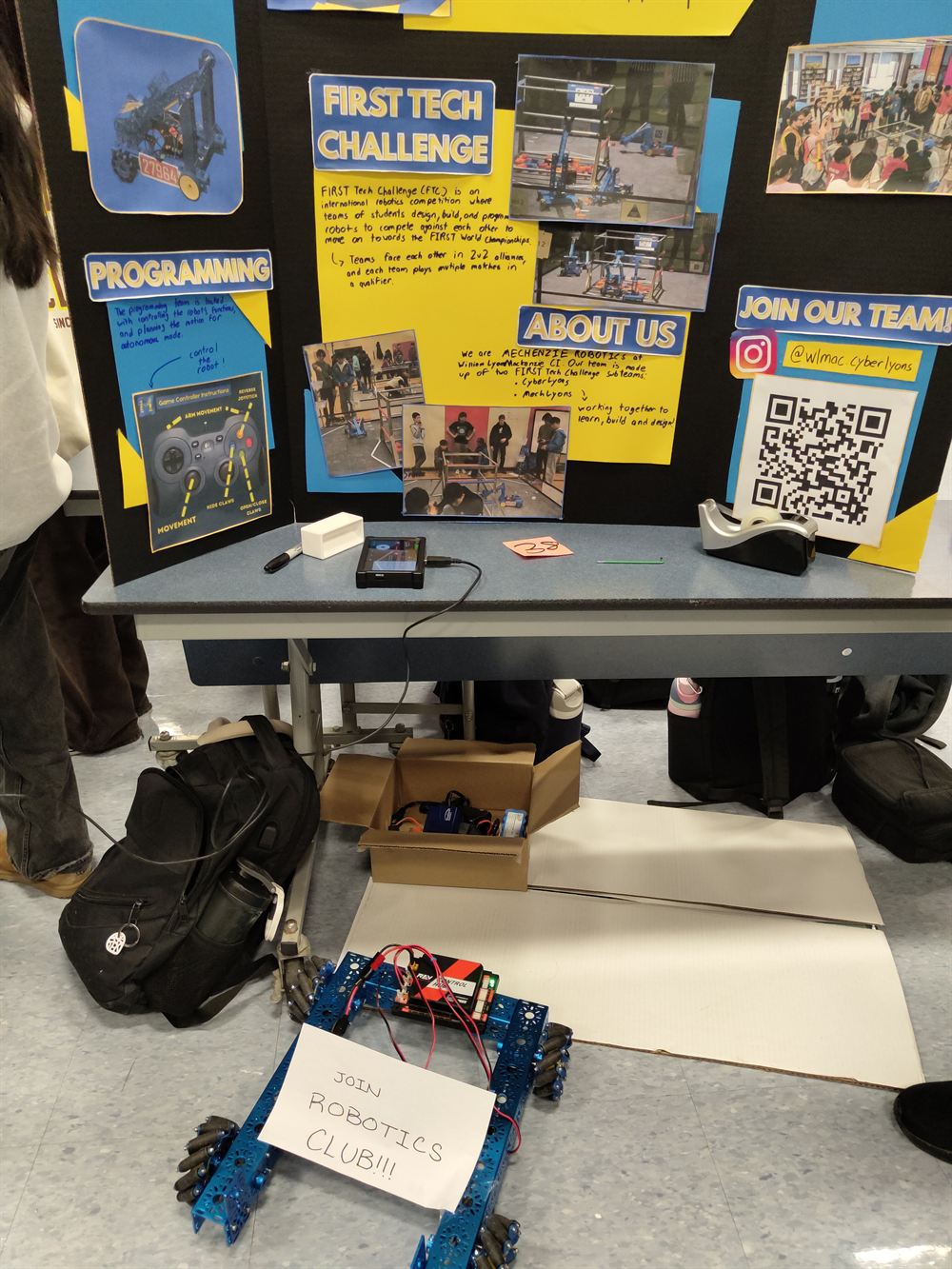 Students and families around the robotics table at Grade 9 Night