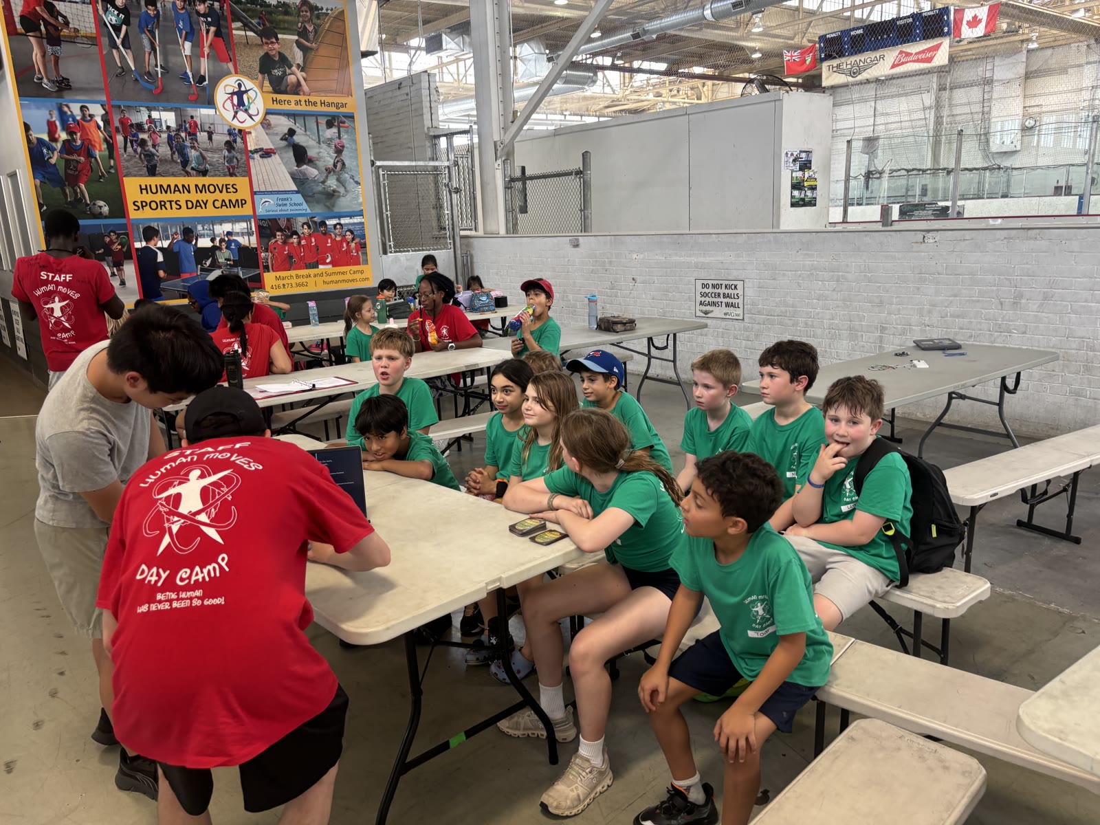 Campers seated at tables while WLMAC Robotics mentors prepare an Arduino workshop at Human Moves Sports Camp