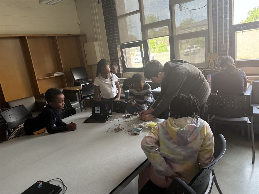 Students working with robots at the Joyce community event