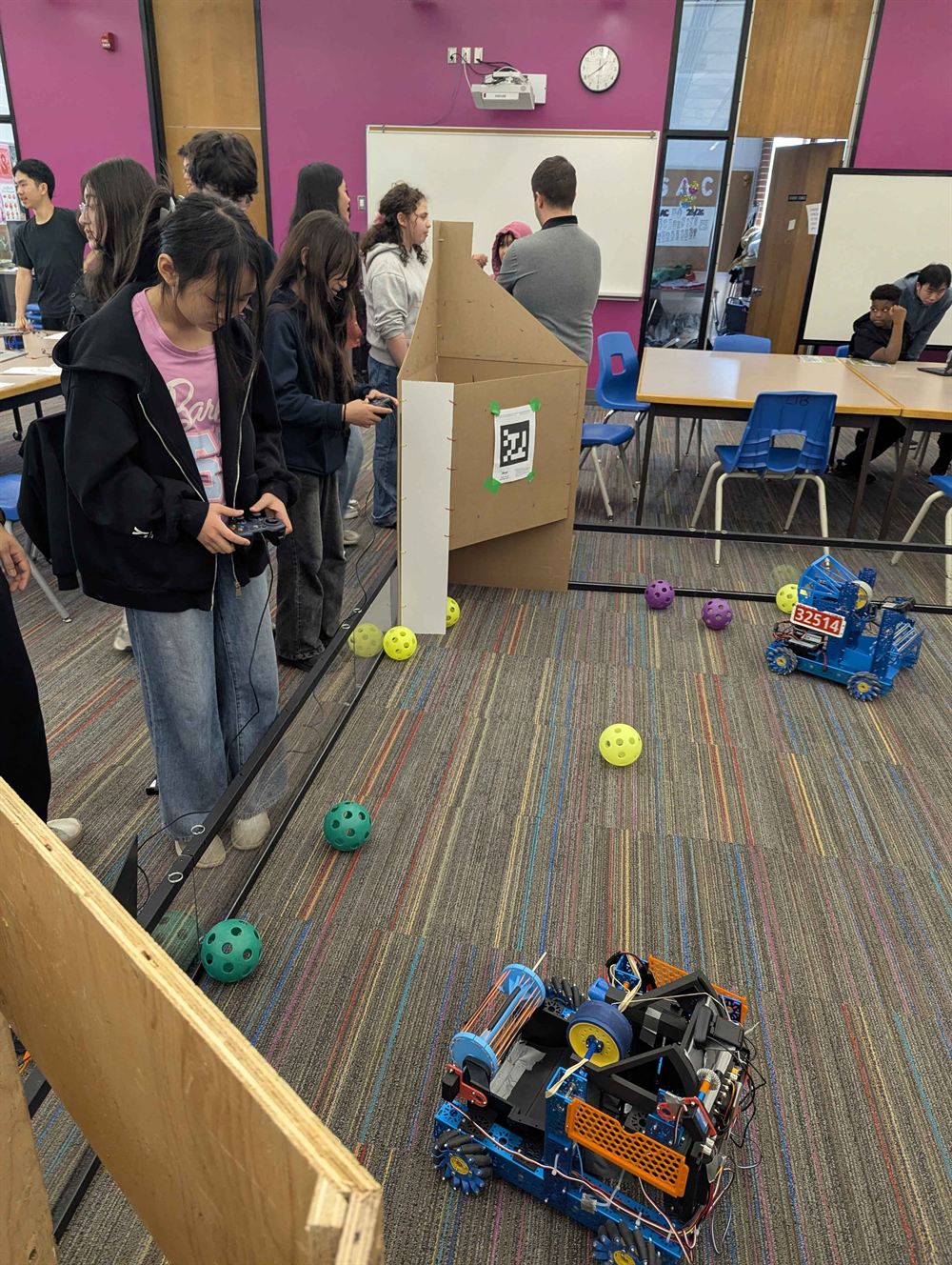 Students building and driving robots at the Library Open House